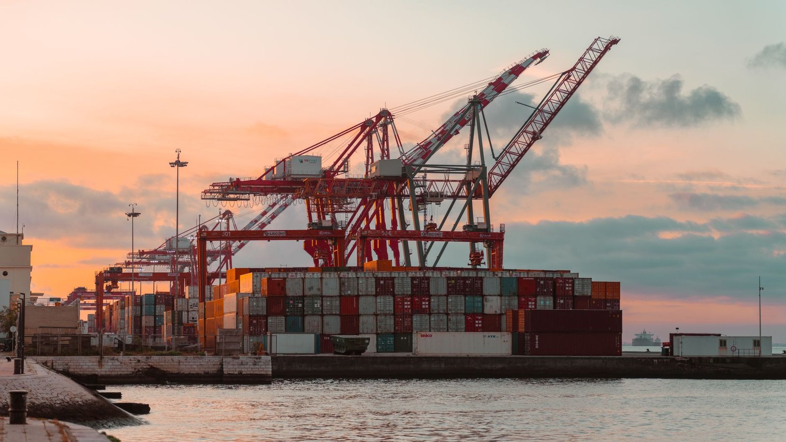 Container port with shipping cranes at dusk